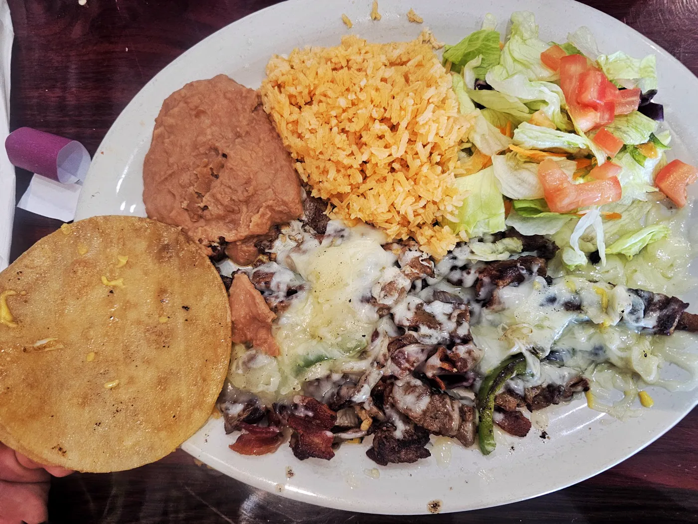 A plated meal with rice, beans, salad, tortilla, and cheese photographed at El Dorado Restaurant